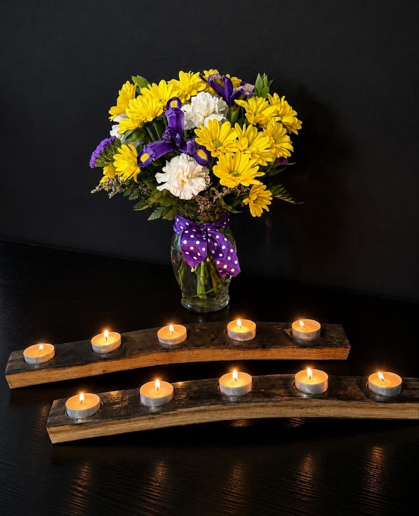Reclaimed bourbon barrel stave tealight candle holders beside a vase of flowers